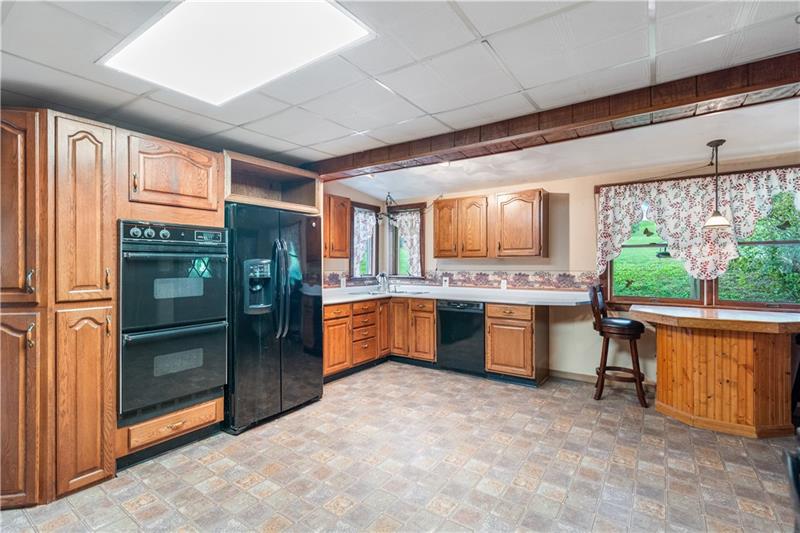 218 Outcrop Road Smithfield, PA 15478 - Photo 10 of 21 a large kitchen with stainless steel appliances granite countertop a refrigerator a sink and a stove