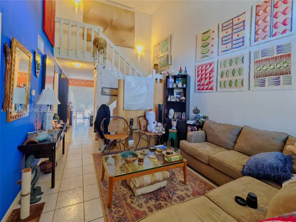 a living room with furniture and a rug
