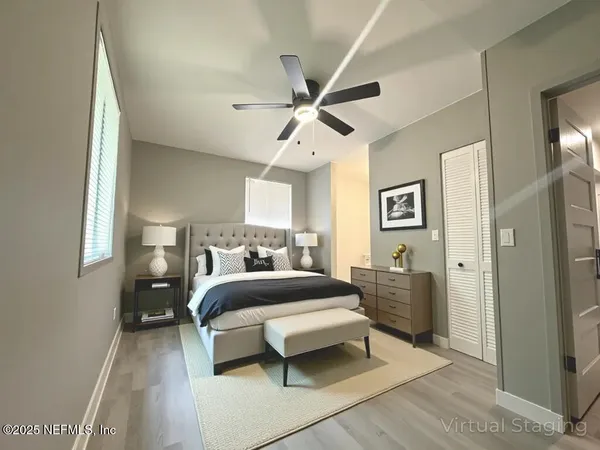 a bedroom with a bed and a chandelier