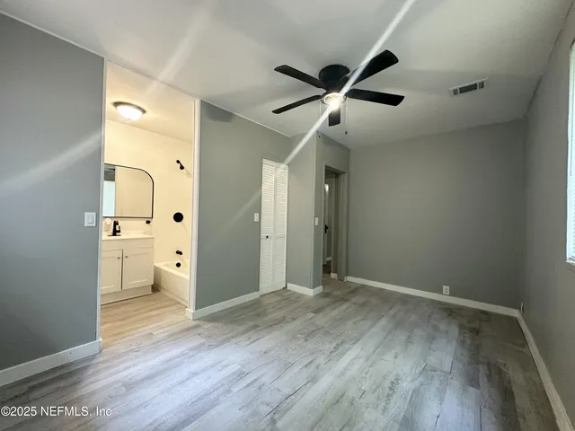 a view of an empty room and wooden floor