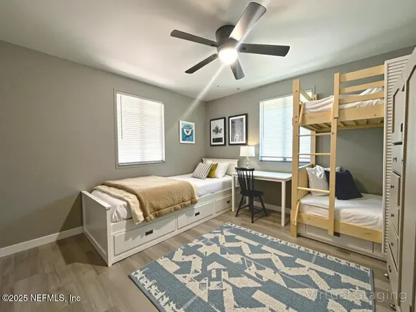 a spacious bedroom with a bed and a chandelier