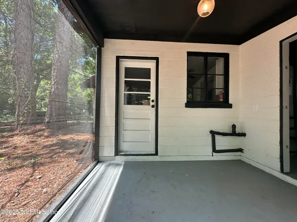 a view of a house with backyard and porch