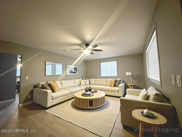 a living room with furniture a rug and a window