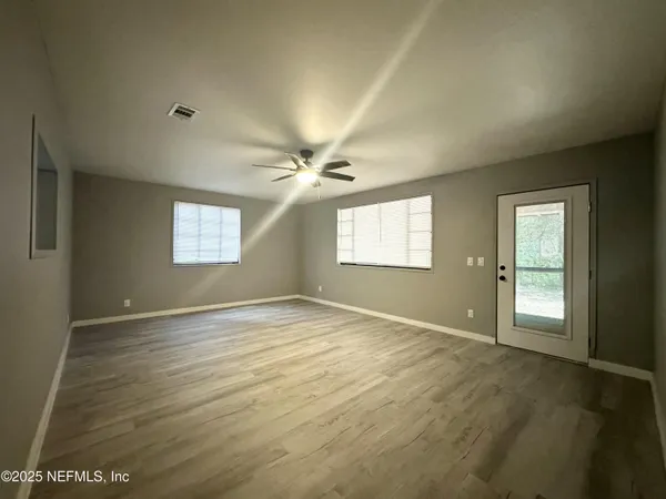 a view of an empty room with a window