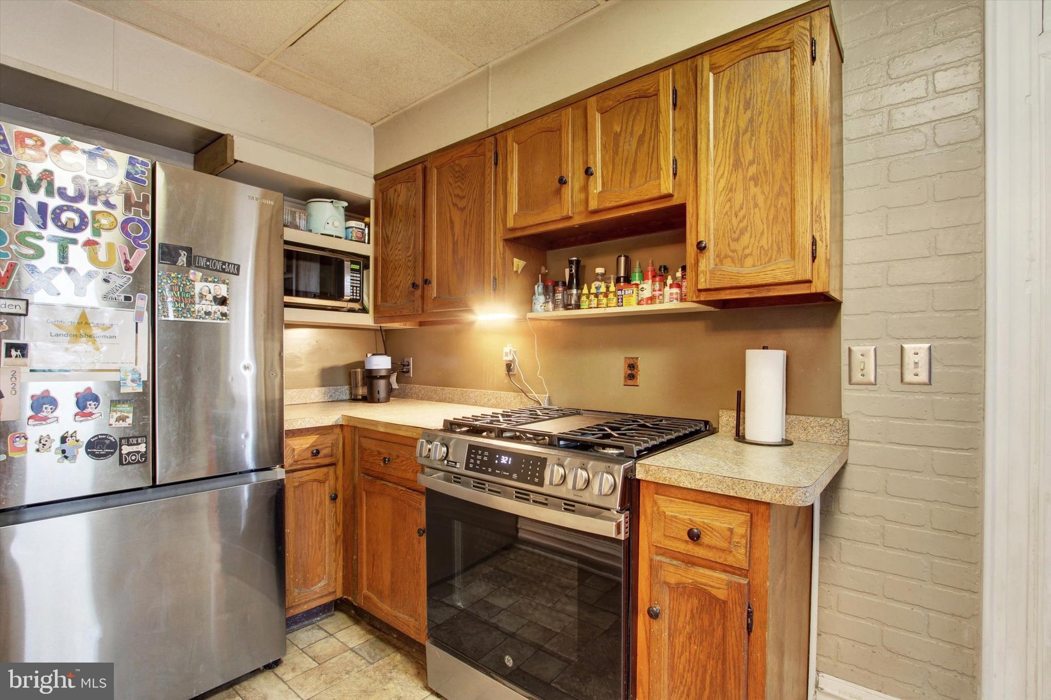 614 Broadway Hanover, PA 17331 - Photo 14 of 33 a kitchen with stainless steel appliances granite countertop a stove a refrigerator and a sink