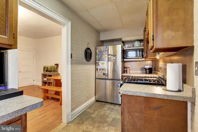 a kitchen with stainless steel appliances granite countertop a stove and a refrigerator