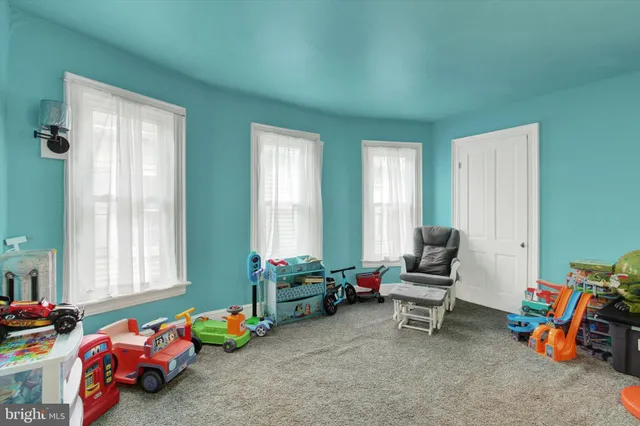 a playing room with toys and a window