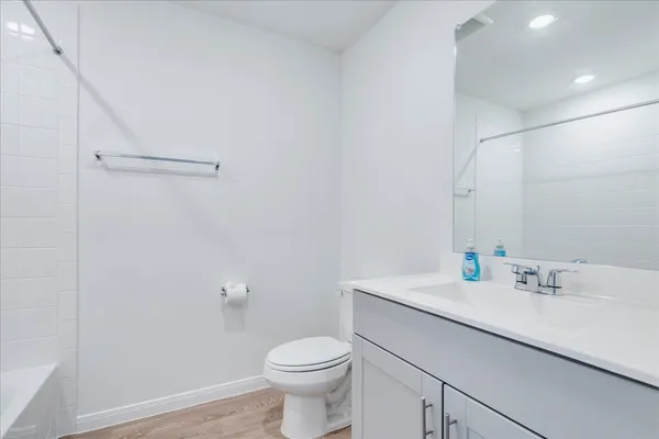 a bathroom with a sink toilet and vanity