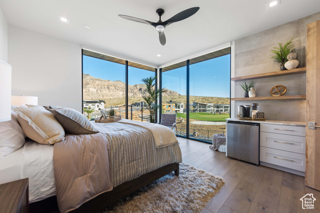 3558 South Cypress Road Hurricane, UT 84737 - Photo 24 of 57 Bedroom with floor to ceiling windows, light hardwood / wood-style flooring, ceiling fan, access to exterior, and fridge