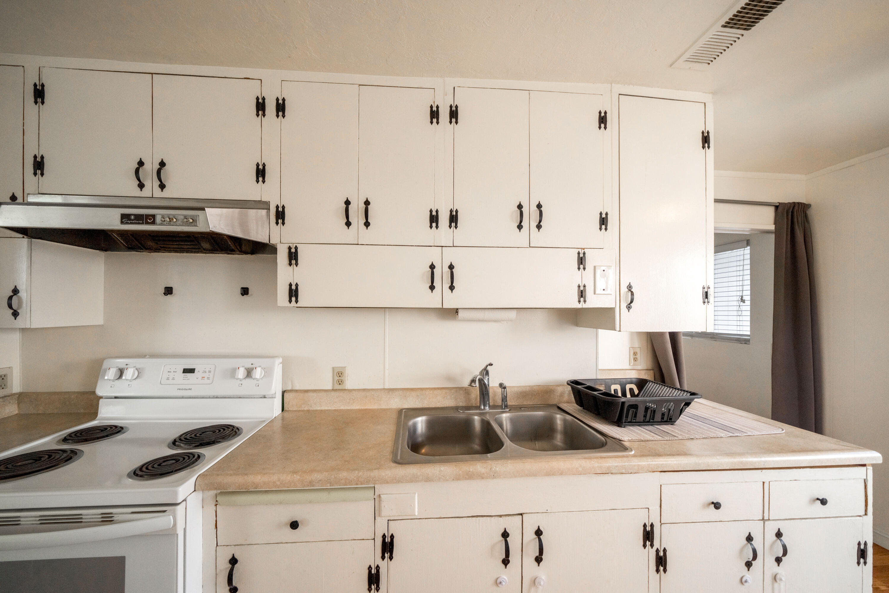 240 Kimball Road Red Bluff, CA 96080 - Photo 12 of 56 a kitchen with cabinets appliances a sink and a counter top