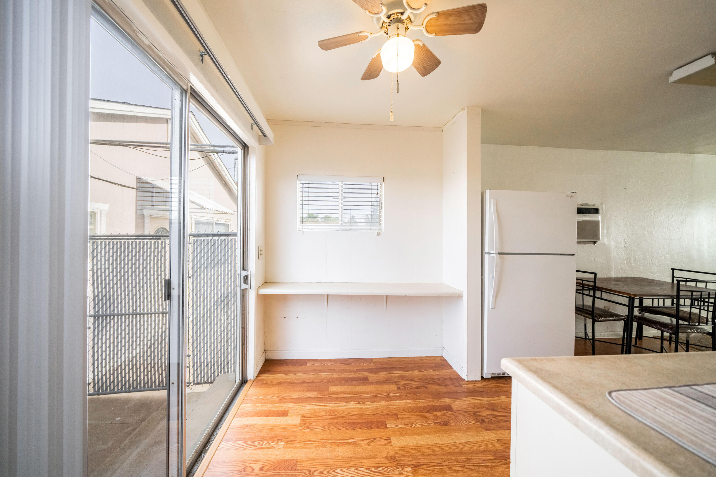 240 Kimball Road Red Bluff, CA 96080 - Photo 14 of 56 a view of kitchen and empty room with wooden floor