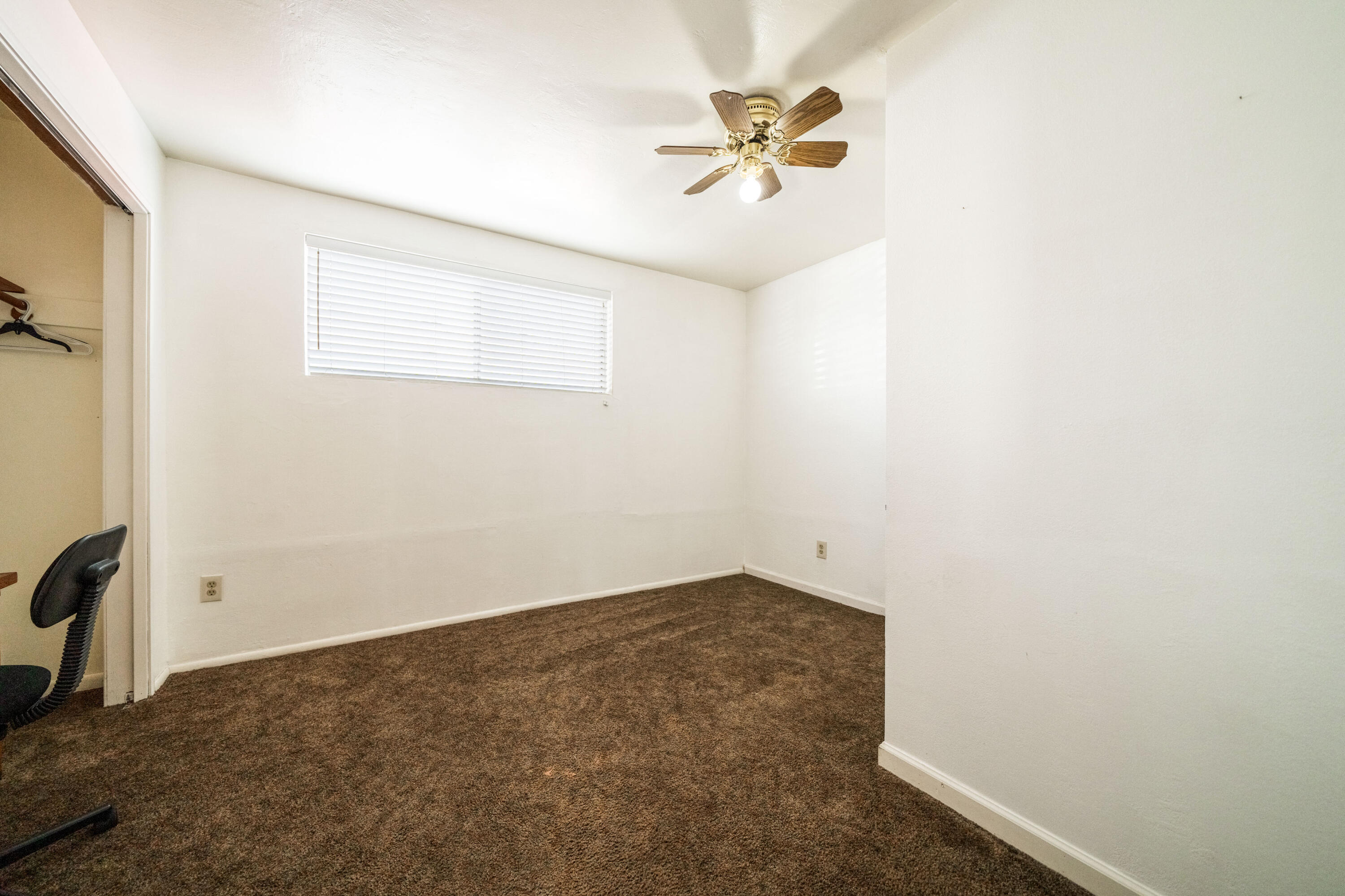 240 Kimball Road Red Bluff, CA 96080 - Photo 22 of 56 an empty room with a ceiling fan and a window