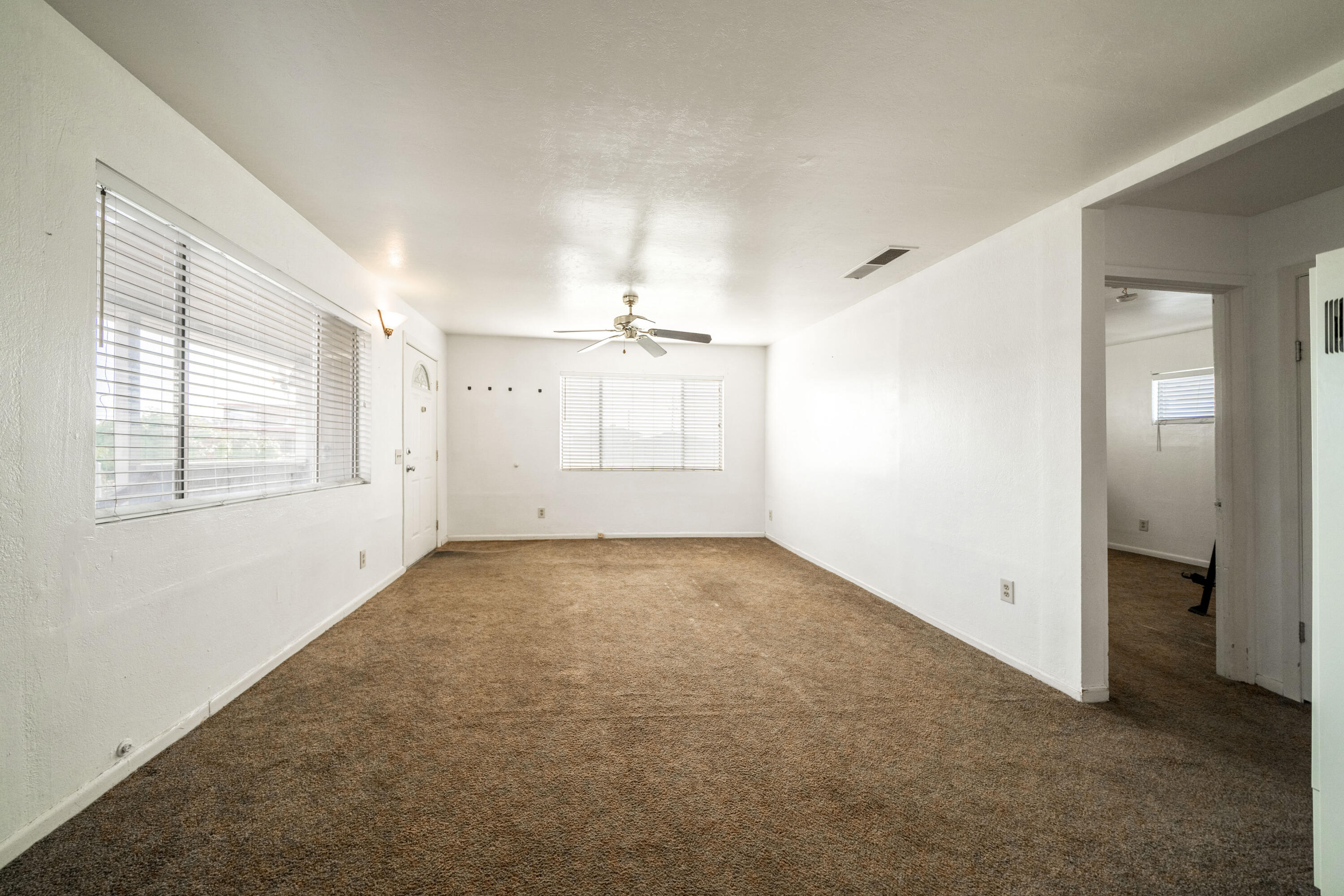 240 Kimball Road Red Bluff, CA 96080 - Photo 6 of 56 an empty room with windows and chandelier fan