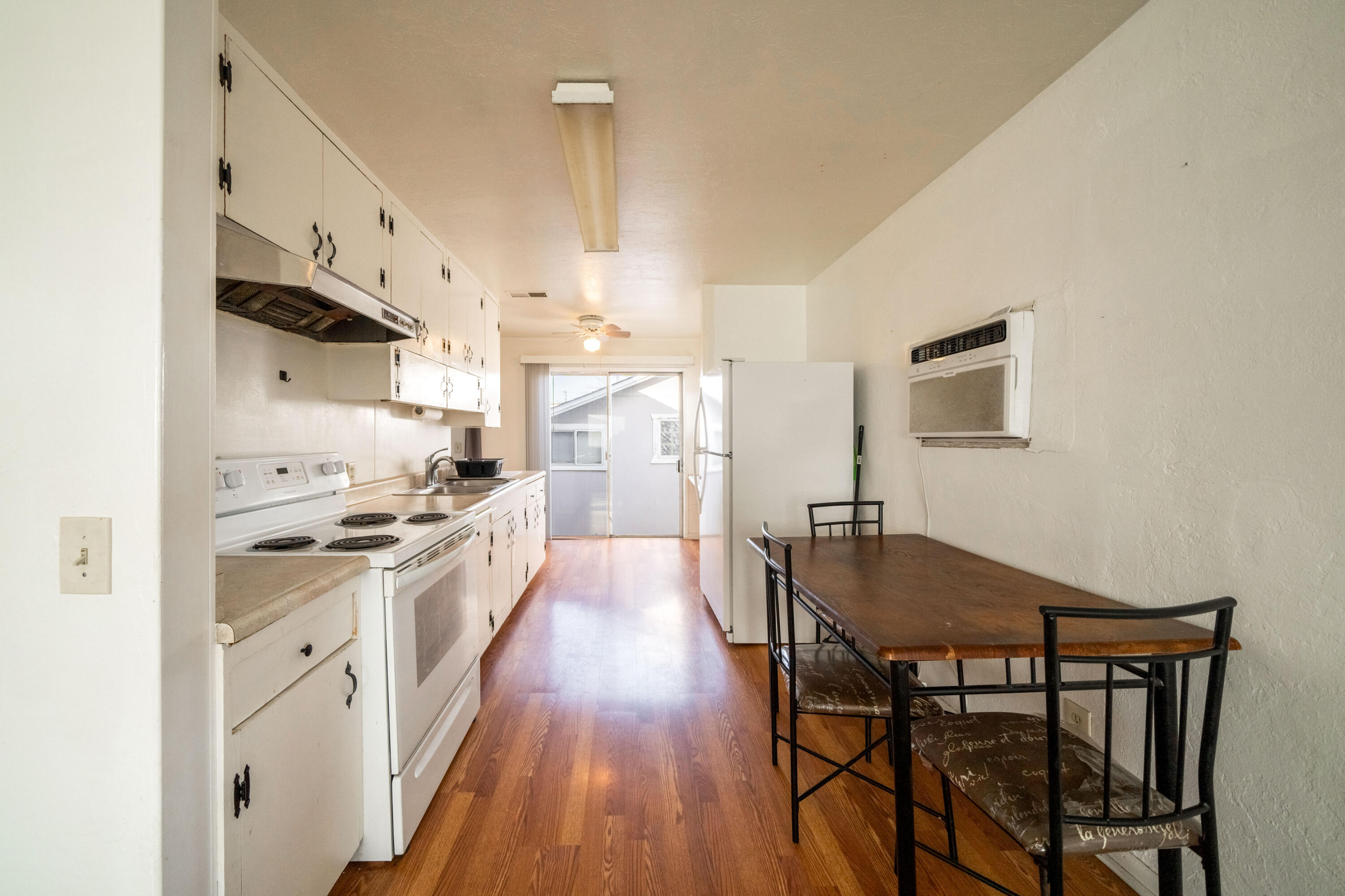 240 Kimball Road Red Bluff, CA 96080 - Photo 10 of 56 a kitchen with stainless steel appliances granite countertop a stove a sink dishwasher and a refrigerator with wooden floor