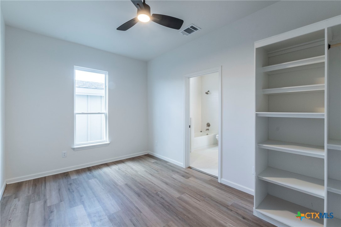 401 South 11th Street Temple, TX 76504 - Photo 16 of 25 a view of an empty room with a window and wooden floor