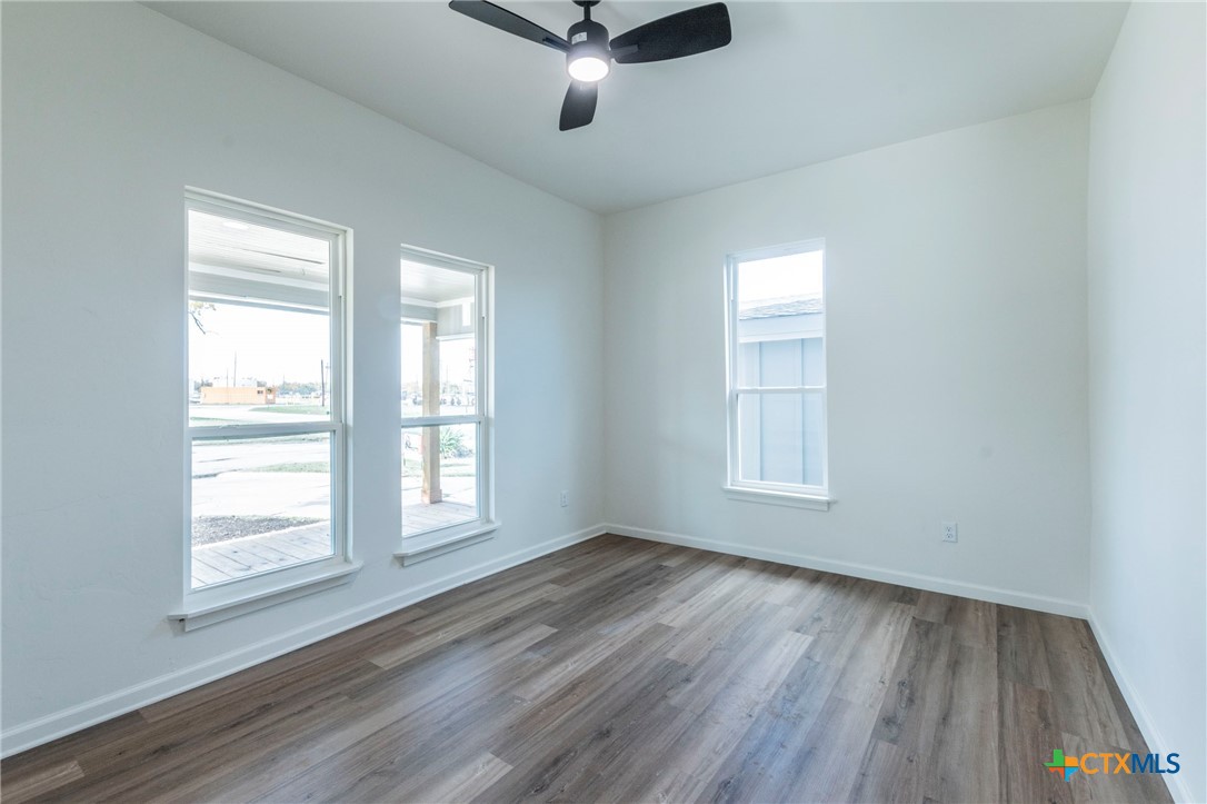 401 South 11th Street Temple, TX 76504 - Photo 19 of 25 a view of an empty room with wooden floor and a window