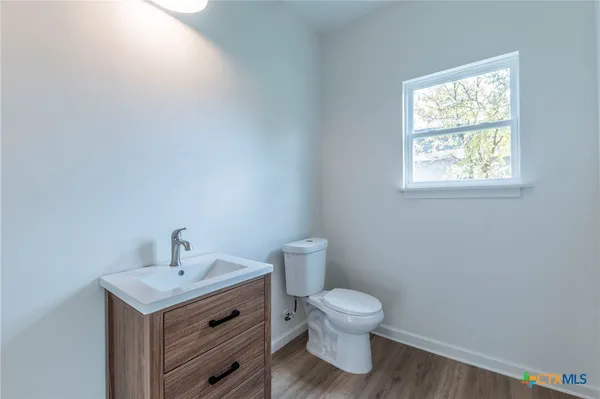 a bathroom with a toilet sink and window