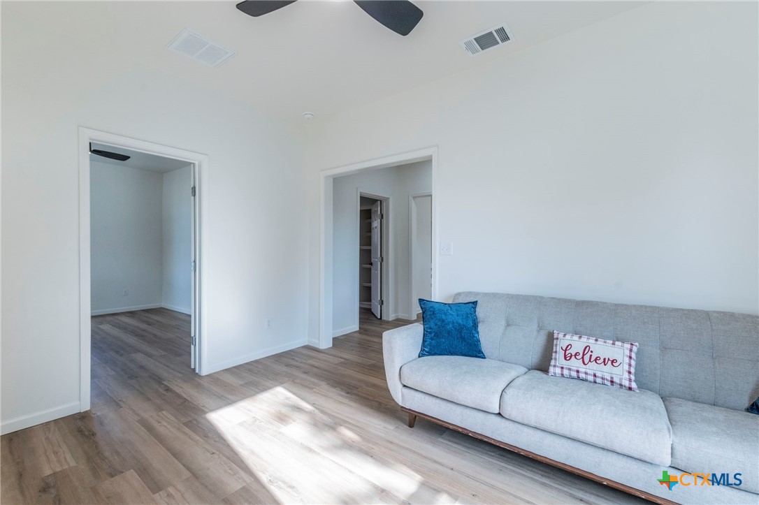 401 South 11th Street Temple, TX 76504 - Photo 6 of 25 a living room with furniture and a wooden floor