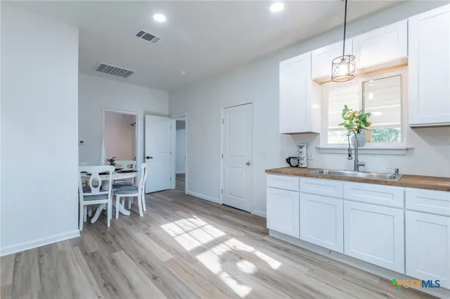 a kitchen with stainless steel appliances kitchen island granite countertop a sink and cabinets