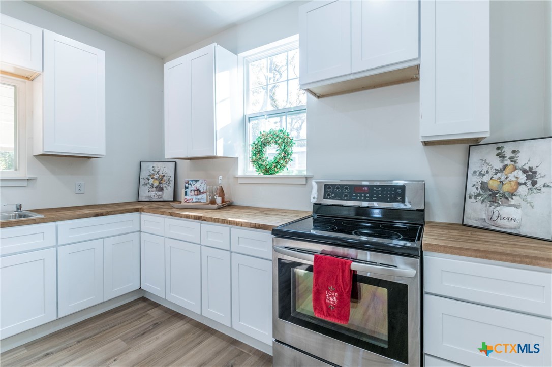 401 South 11th Street Temple, TX 76504 - Photo 10 of 25 a kitchen with stainless steel appliances a stove a sink and a microwave
