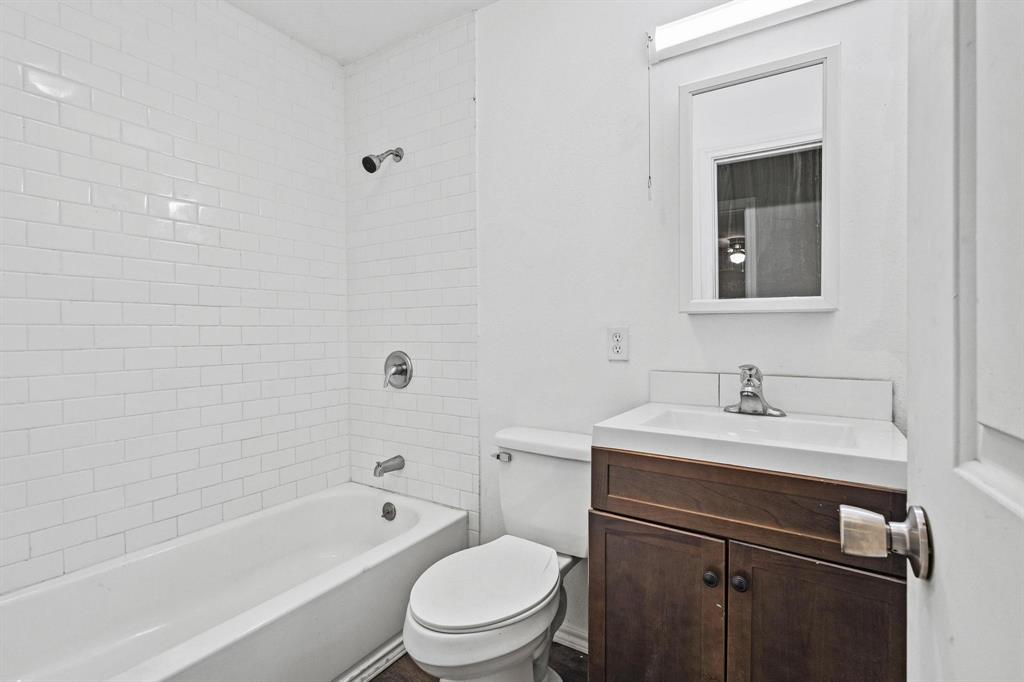 701 West Hull Street, Unit 1012 Denison, TX 75020 - Photo 13 of 20 a bathroom with a sink a toilet and vanity