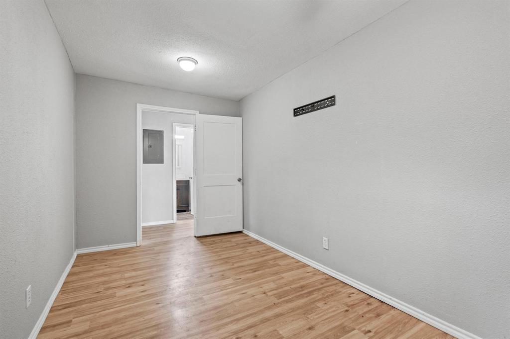 701 West Hull Street, Unit 1012 Denison, TX 75020 - Photo 17 of 20 a view of an empty room with wooden floor