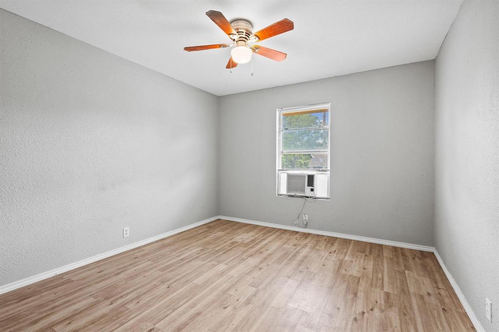 701 West Hull Street, Unit 1012 Denison, TX 75020 - Photo 8 of 20 an empty room with wooden floor and windows