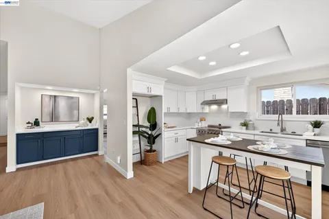a kitchen with a sink cabinets and wooden floor