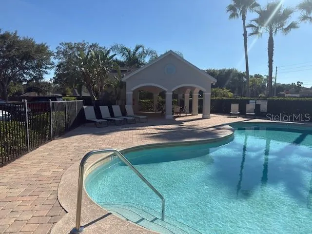a swimming pool with outdoor seating and yard