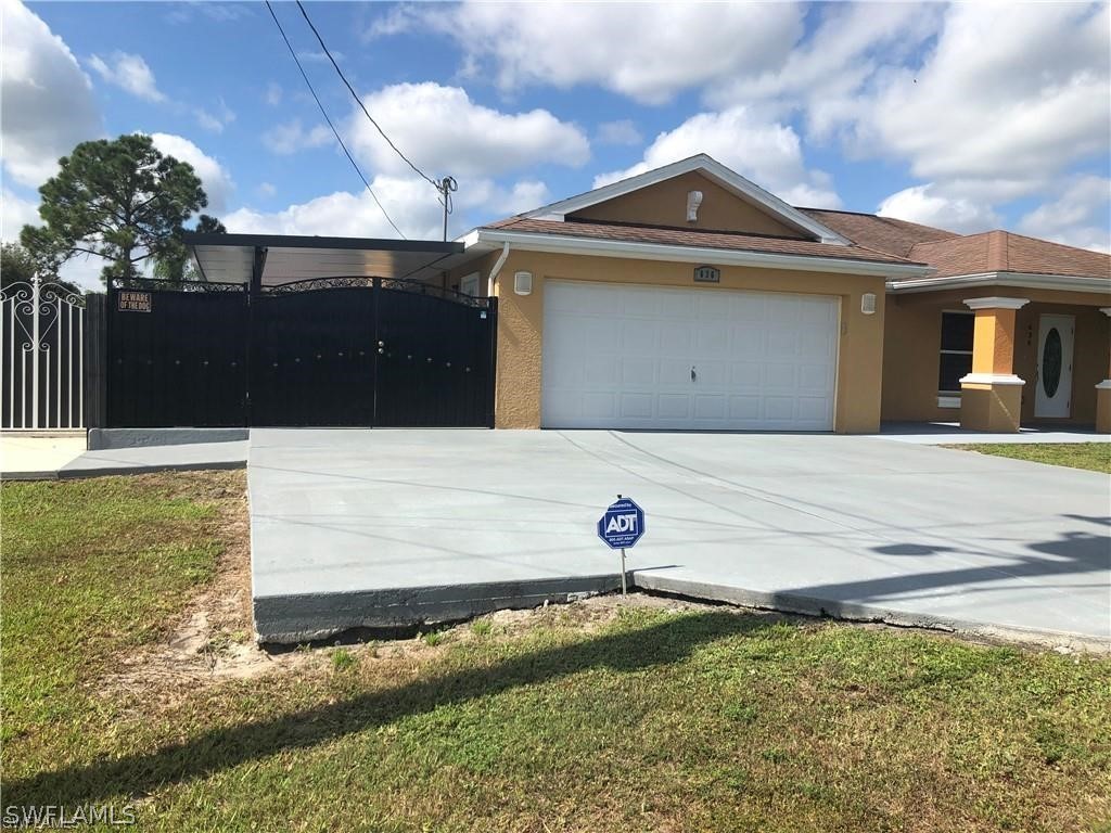 636 Homestead Road South Lehigh Acres, FL 33974 - Photo 4 of 30 a front view of a house with garden