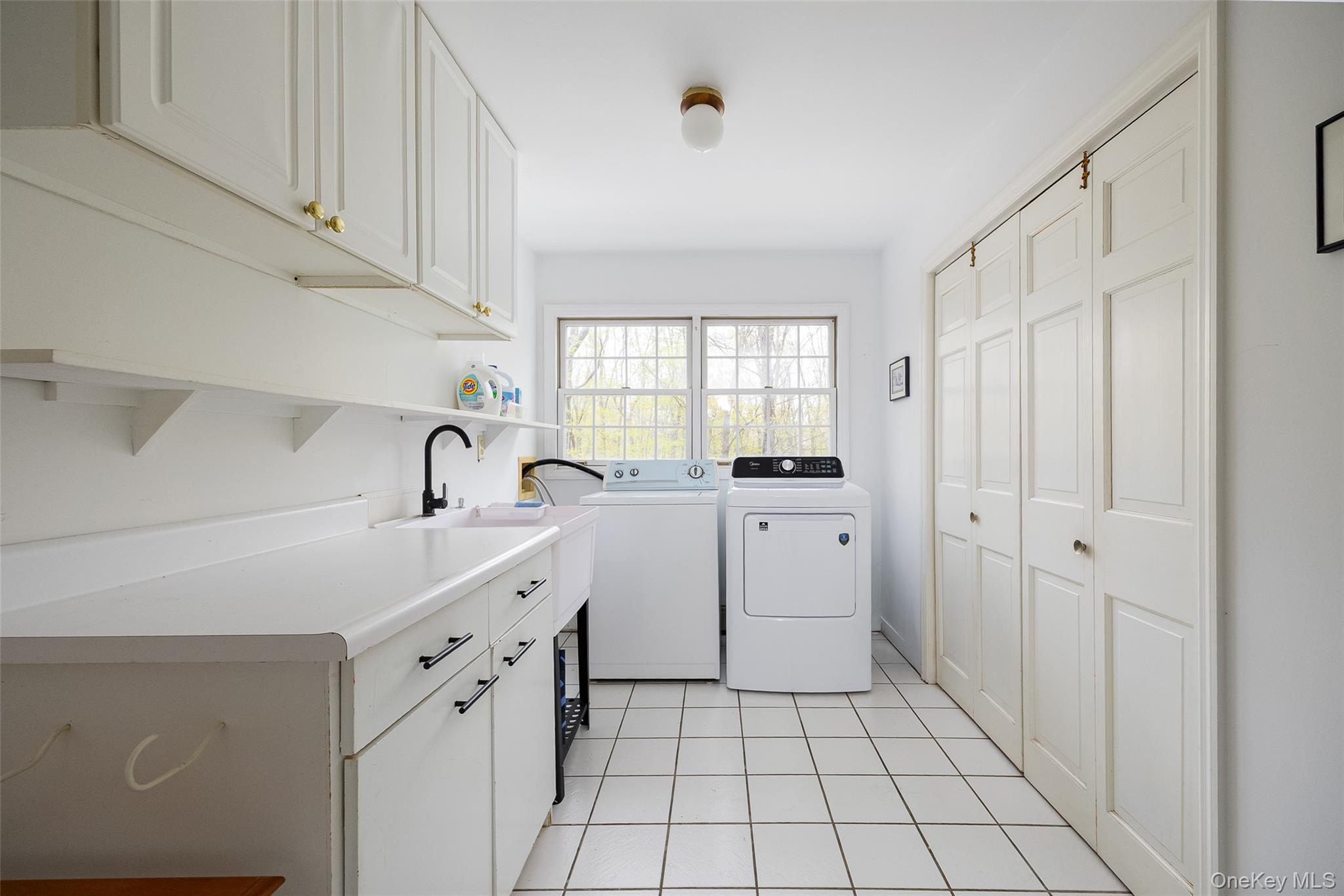 33 Willow Brook Ridge Clinton Corners, NY 12514 - Photo 42 of 50 a kitchen with white cabinets a sink a stove and a window