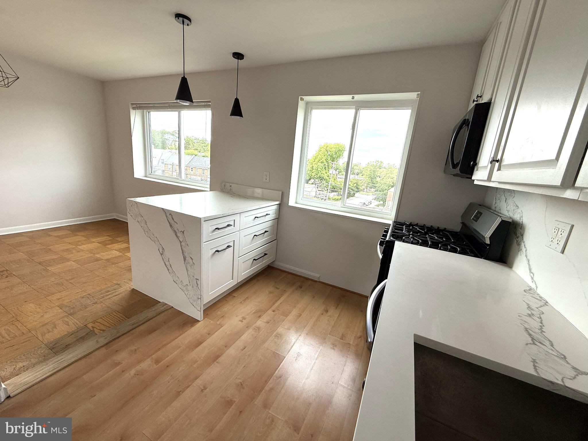 614 Sligo Avenue, Unit 411 Silver Spring, MD 20910 - Photo 12 of 24 a kitchen with a wooden floor and window