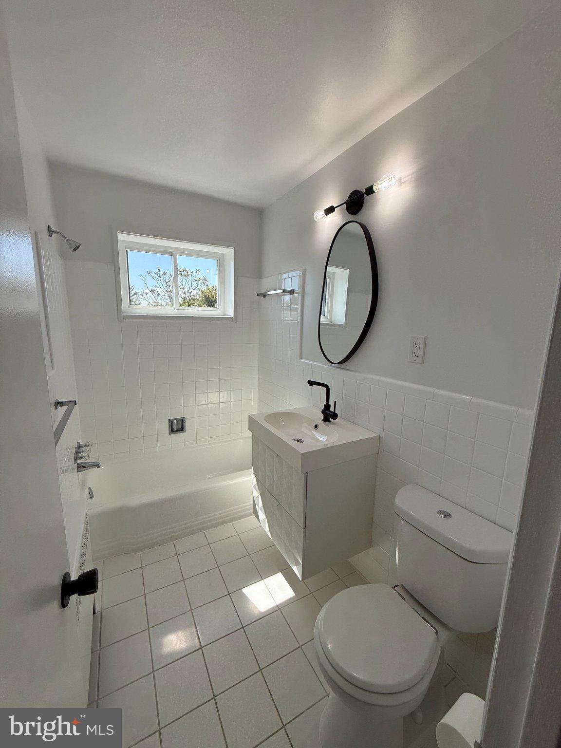 614 Sligo Avenue, Unit 411 Silver Spring, MD 20910 - Photo 17 of 24 a bathroom with a toilet sink and mirror