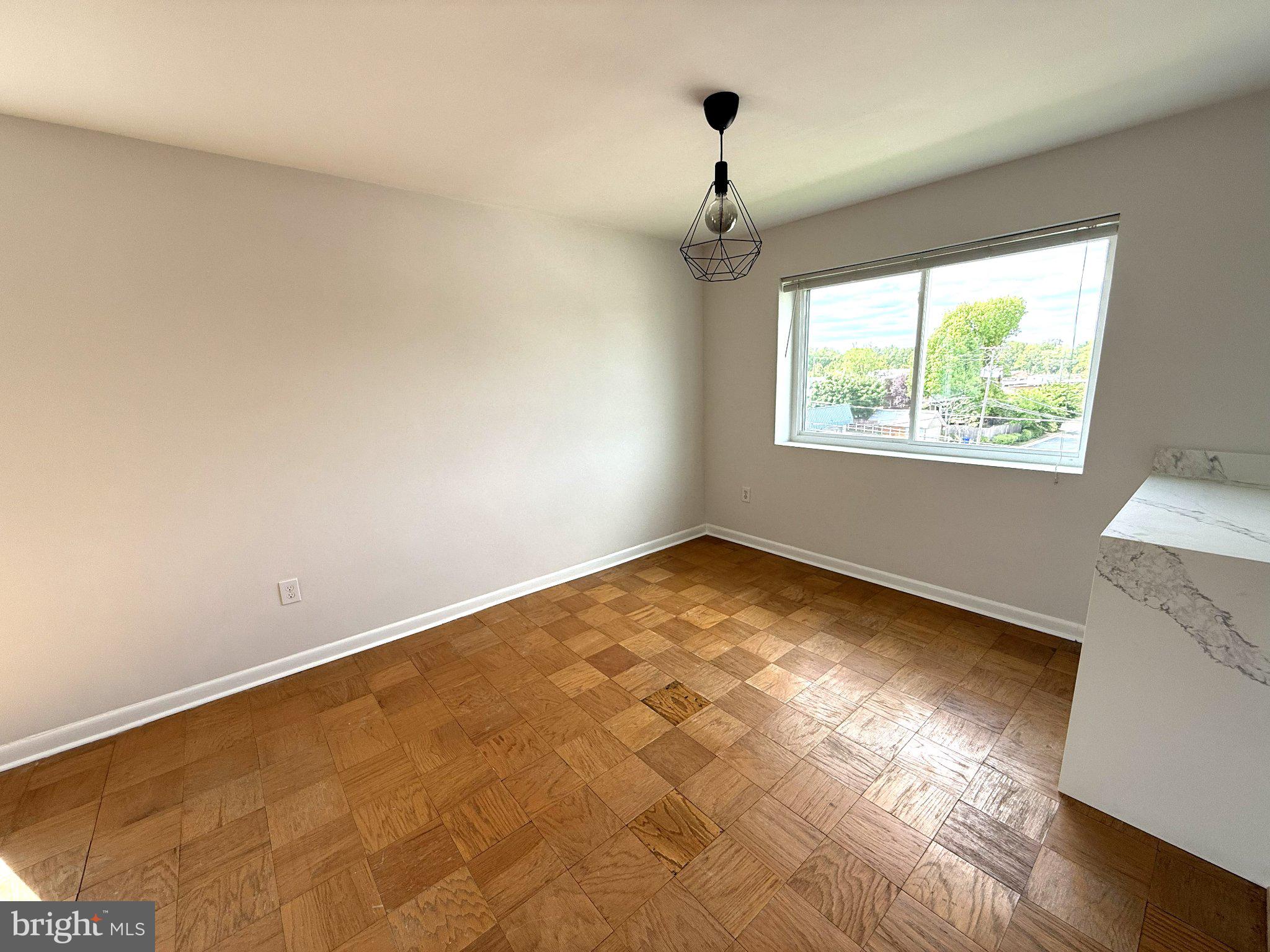 614 Sligo Avenue, Unit 411 Silver Spring, MD 20910 - Photo 6 of 24 an empty room with a window