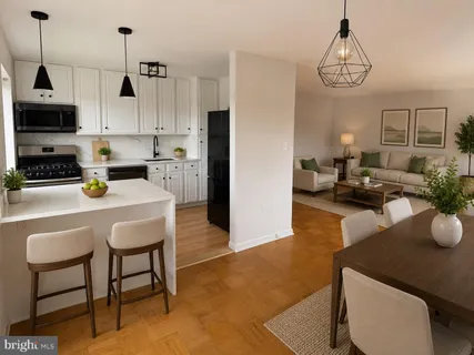 a kitchen with stainless steel appliances kitchen island granite countertop a sink a stove a dining table and chairs with wooden floor