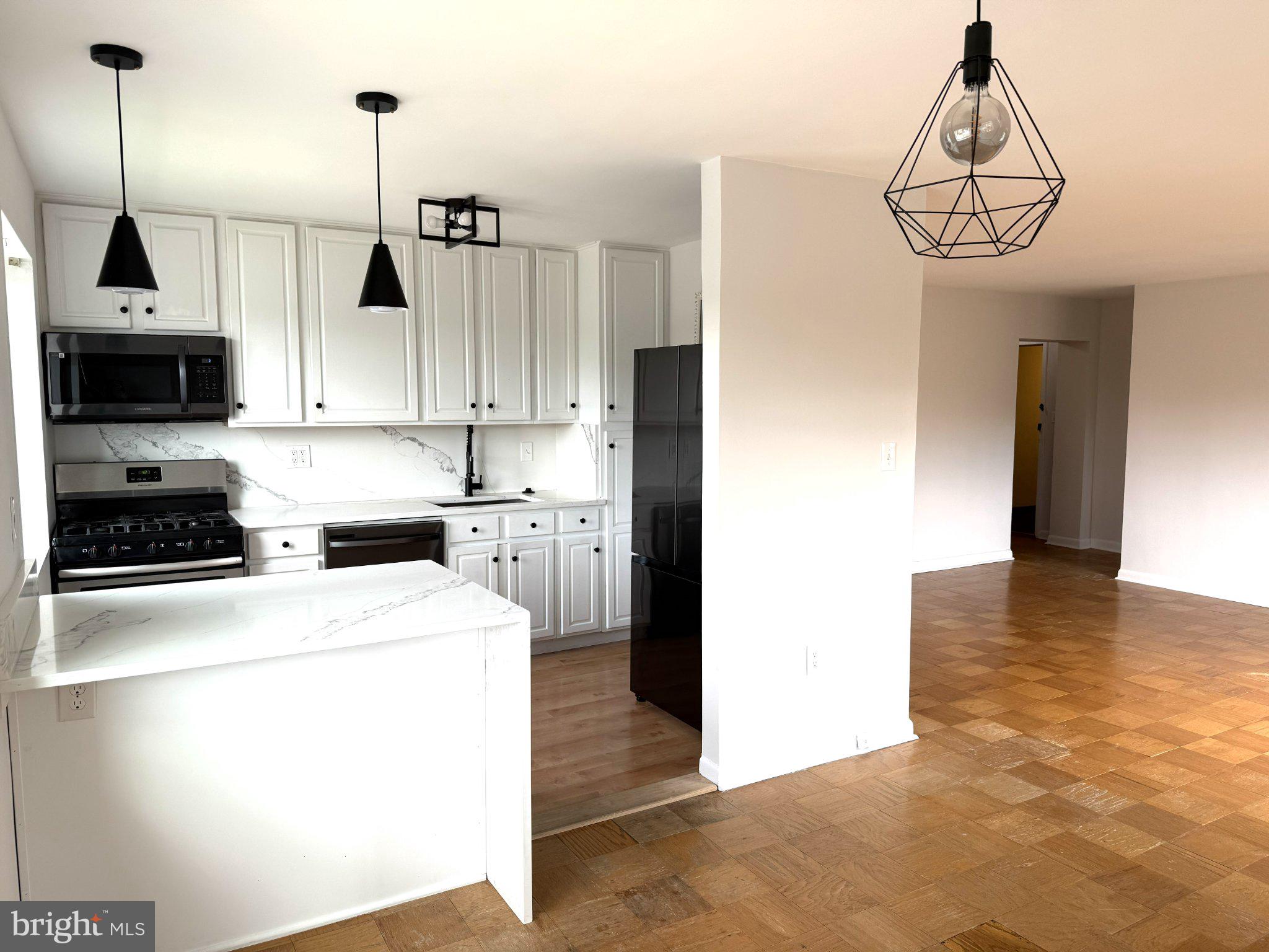 614 Sligo Avenue, Unit 411 Silver Spring, MD 20910 - Photo 10 of 24 a kitchen that has a lot of cabinets and stainless steel appliances