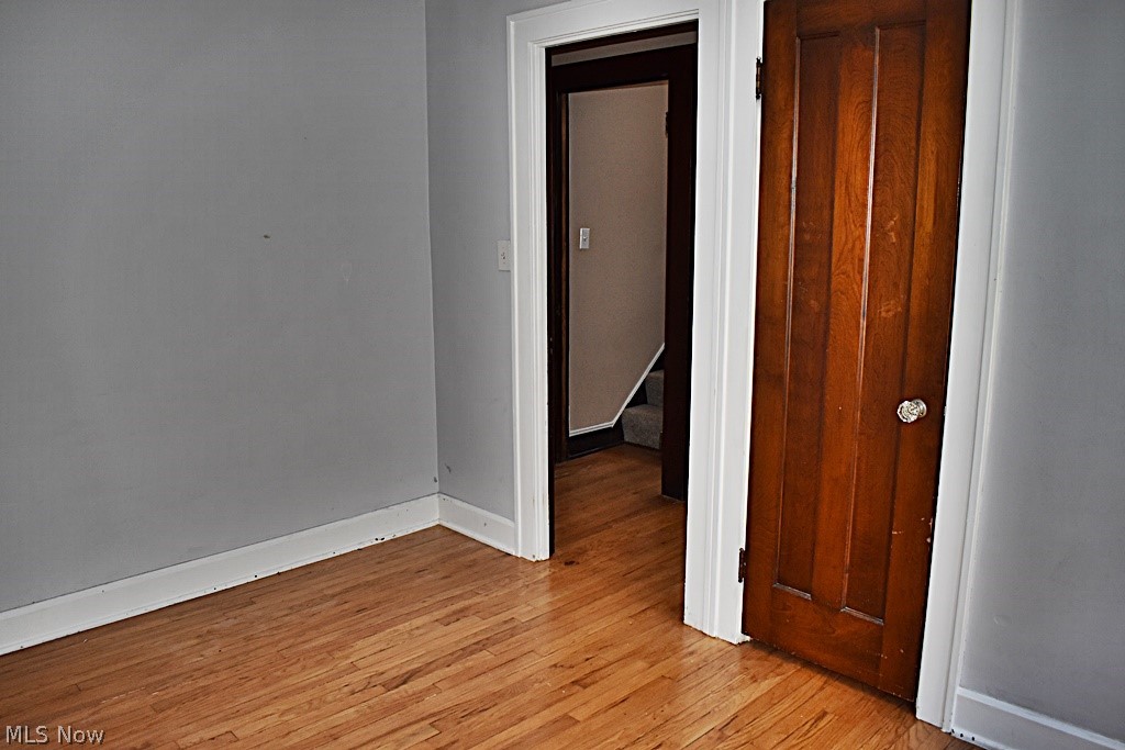 7715 Ackley Road Parma, OH 44129 - Photo 11 of 27 Unfurnished first floor bedroom featuring light hardwood / wood-style flooring