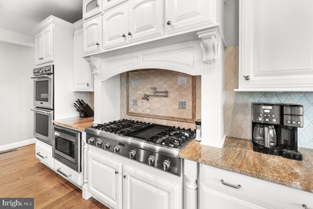 8170 Hollow Road Middletown, MD 21769 - Photo 12 of 67 a kitchen with granite countertop stainless steel appliances and white cabinets