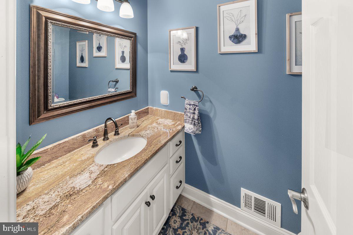 8170 Hollow Road Middletown, MD 21769 - Photo 22 of 67 a bathroom with a granite countertop sink and a mirror