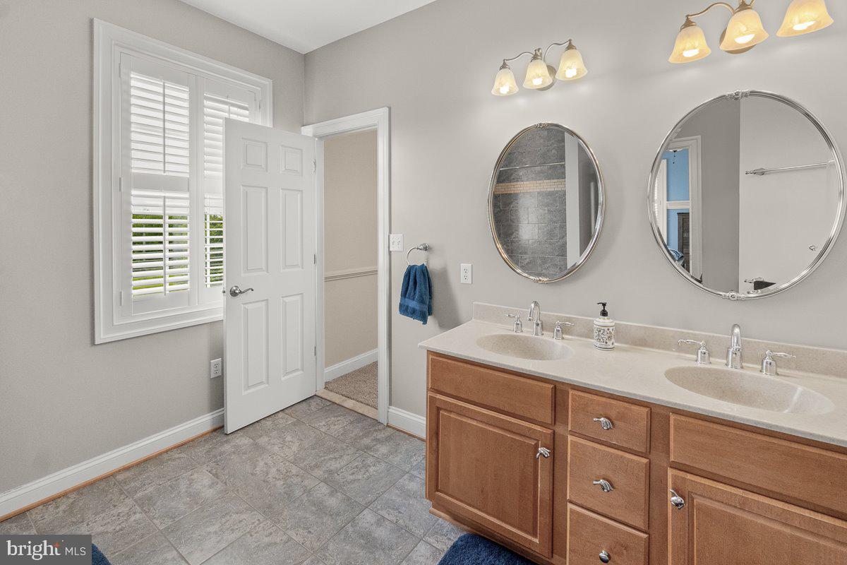 8170 Hollow Road Middletown, MD 21769 - Photo 35 of 67 a bathroom with 2 sink and a mirror