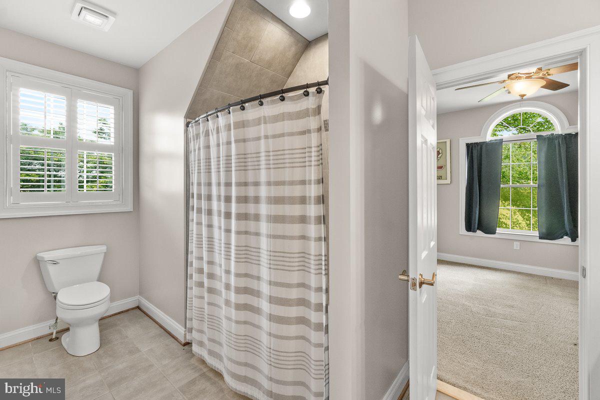 8170 Hollow Road Middletown, MD 21769 - Photo 39 of 67 a bathroom with a toilet a sink and a window