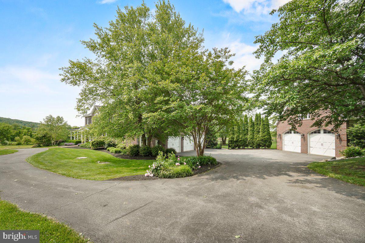 8170 Hollow Road Middletown, MD 21769 - Photo 59 of 67 a front view of a house with a yard and garage