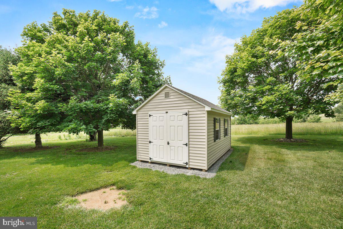 8170 Hollow Road Middletown, MD 21769 - Photo 63 of 67 a view of a backyard with large trees and a small yard