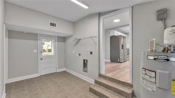 a view of a bathroom with sink mirror and shower