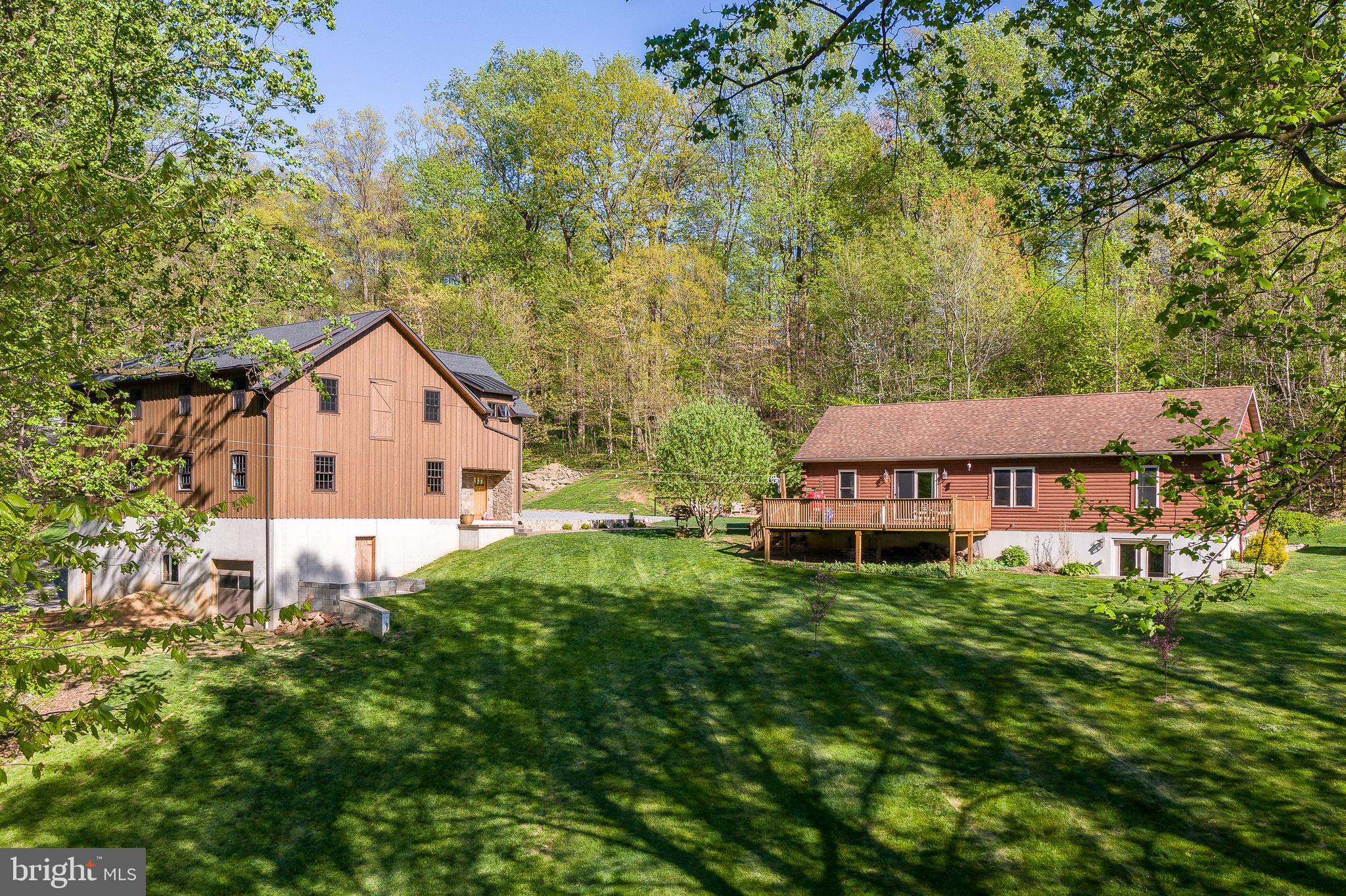 a house view with a garden and a trees