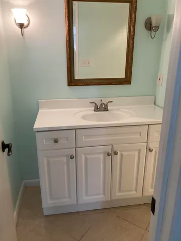 a bathroom with a sink a vanity and a mirror