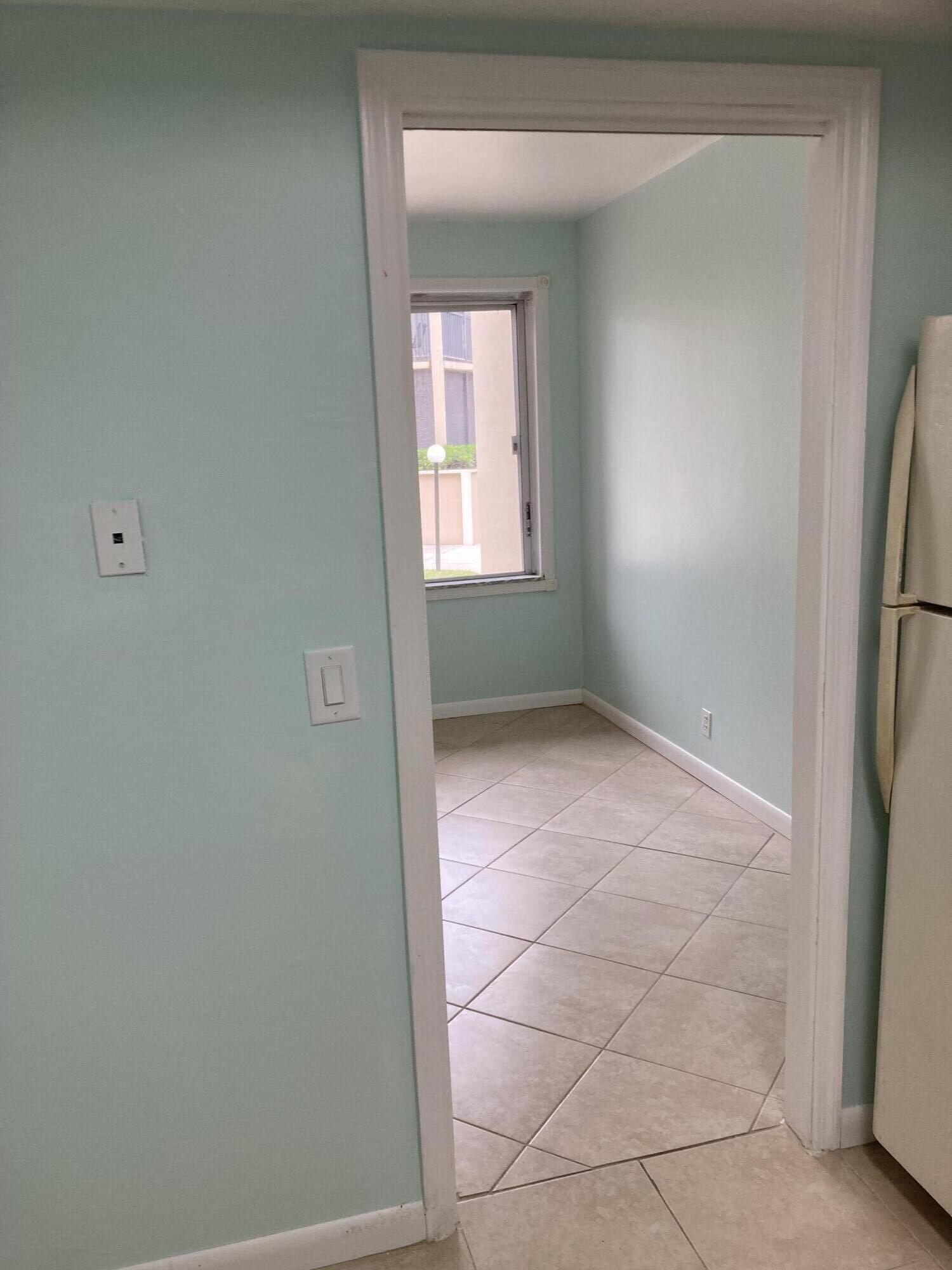 11811 Ave Of The PGA, Unit 21C Palm Beach Gardens, FL 33418 - Photo 13 of 30 a view of an empty room with a window