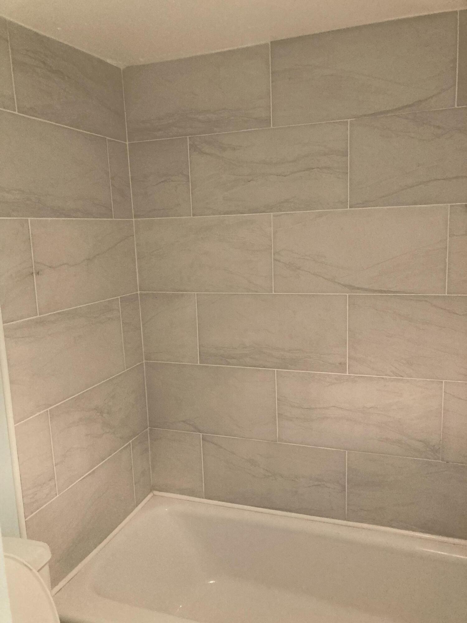 11811 Ave Of The PGA, Unit 21C Palm Beach Gardens, FL 33418 - Photo 14 of 30 a bathroom with a shower