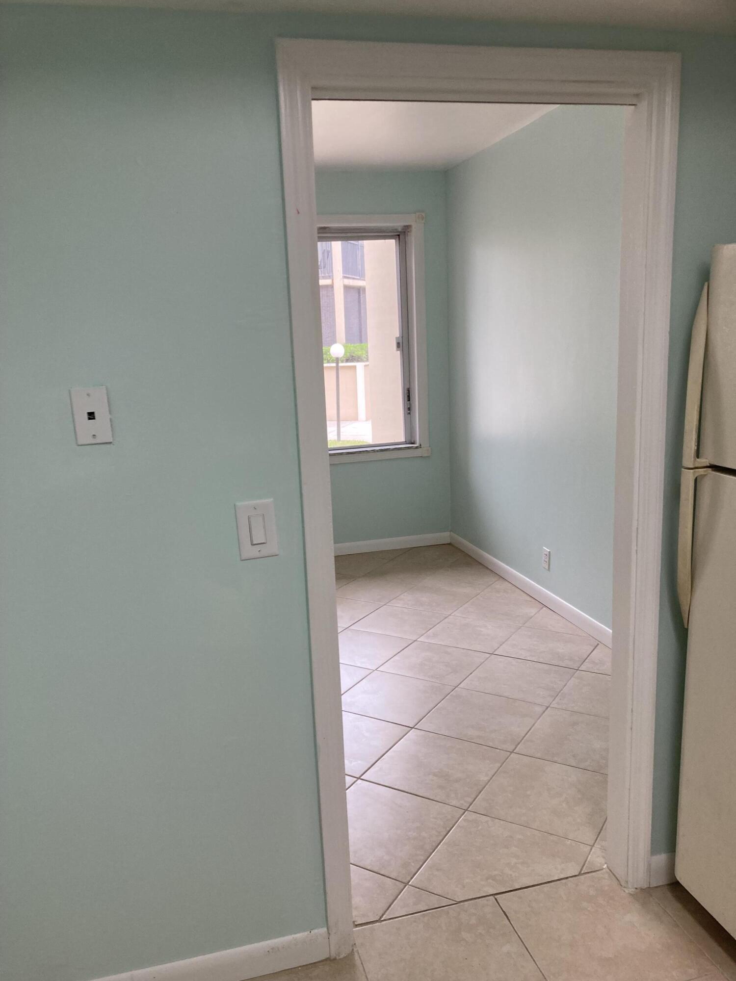 11811 Ave Of The PGA, Unit 21C Palm Beach Gardens, FL 33418 - Photo 18 of 30 a view of an empty room with a window