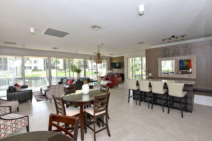 11811 Ave Of The PGA, Unit 21C Palm Beach Gardens, FL 33418 - Photo 2 of 30 a view of a dining room with furniture window and outside view